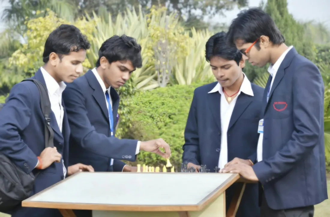 Students playing chess on the college lawns